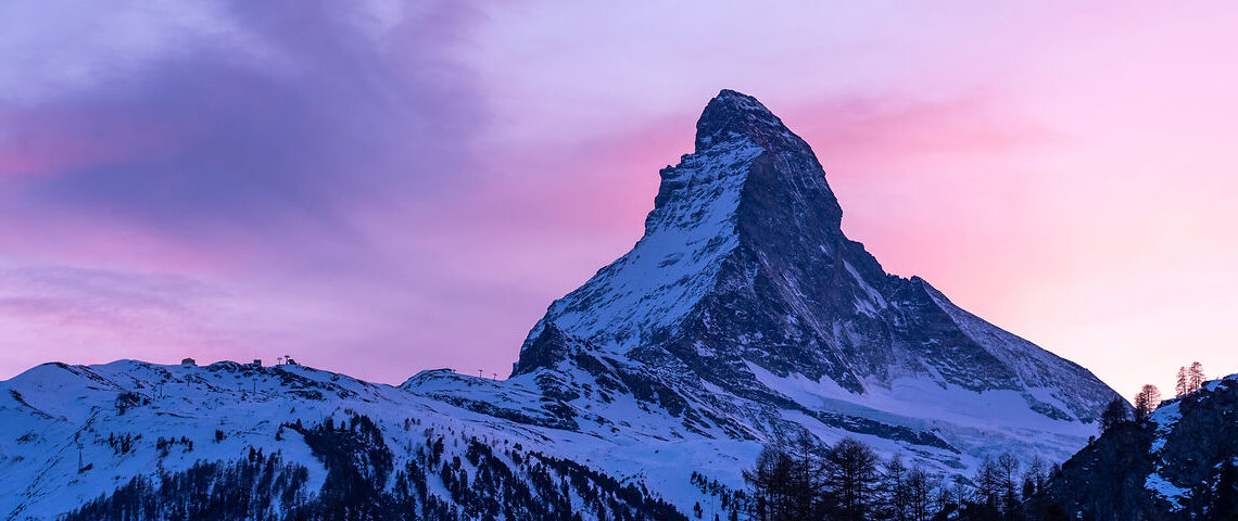 Matterhorn at Sunset in Zermatt The Matterhorn at sunset above Zermatt with snow-covered peaks and a colorful alpine sky.