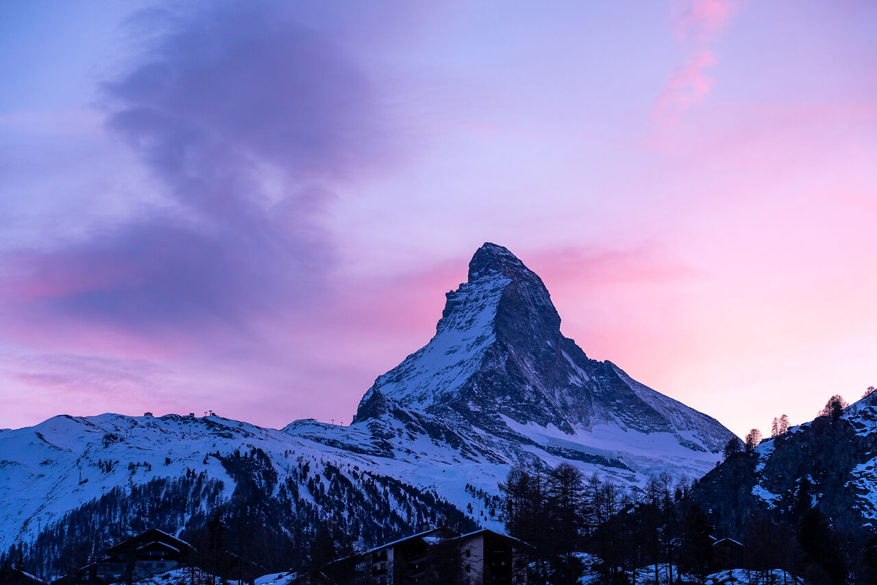 Matterhorn at Sunset in Zermatt The Matterhorn at sunset above Zermatt with snow-covered peaks and a colorful alpine sky.