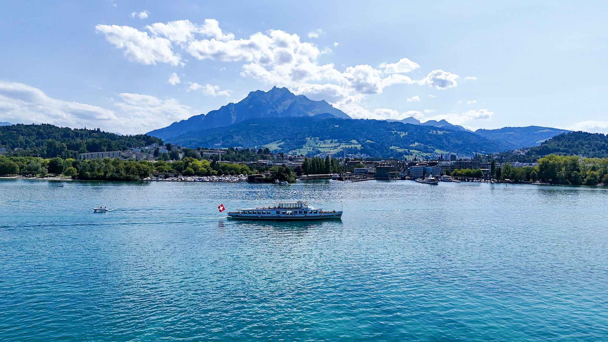 Mount Pilatus & Lake Lucerne | Scenic Drone View | SwissMounts Drone view of a historic paddle steamer on Lake Lucerne with Mount Pilatus in the background, Central Switzerland.