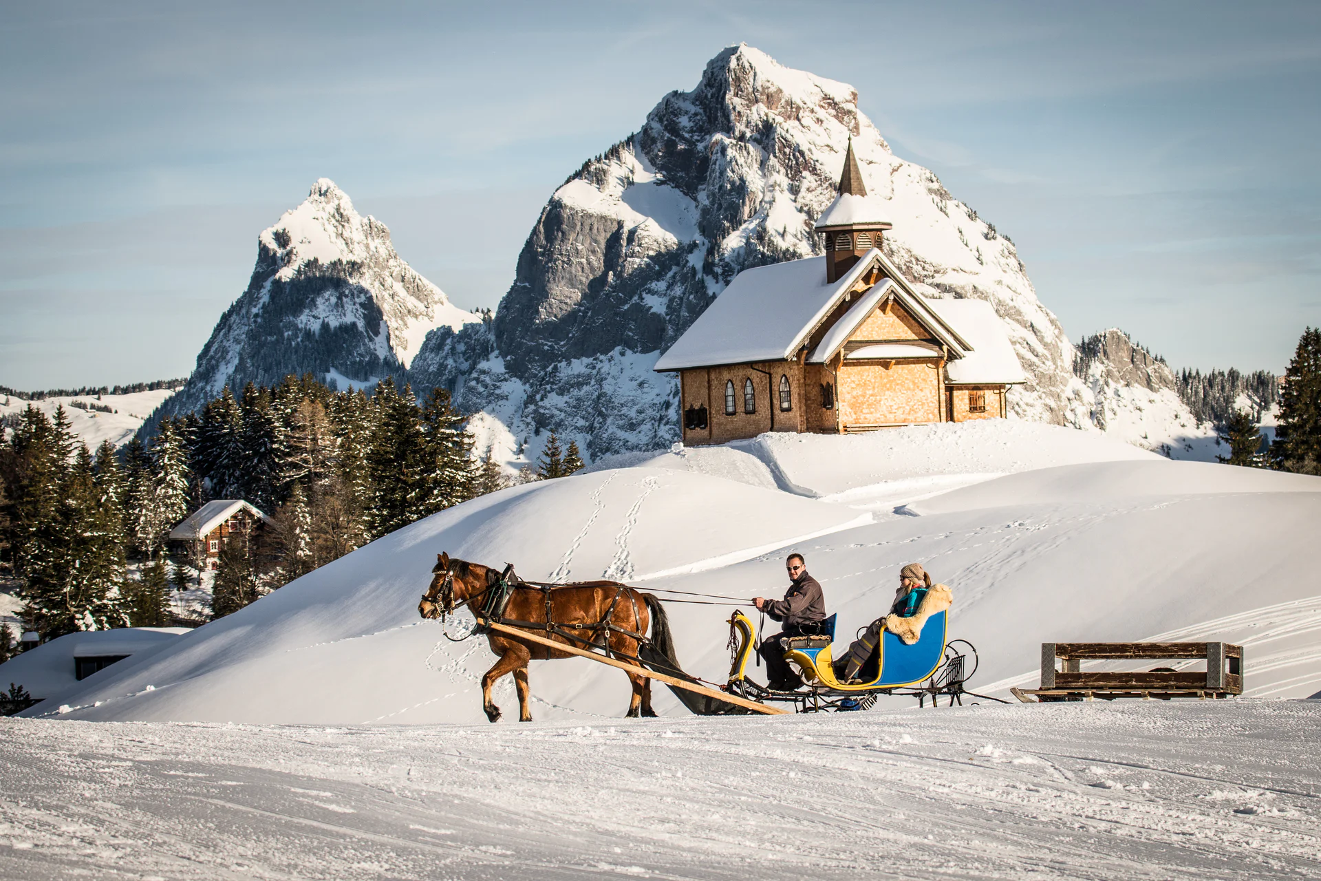Horse-drawn carriage in the winter village of Stoos