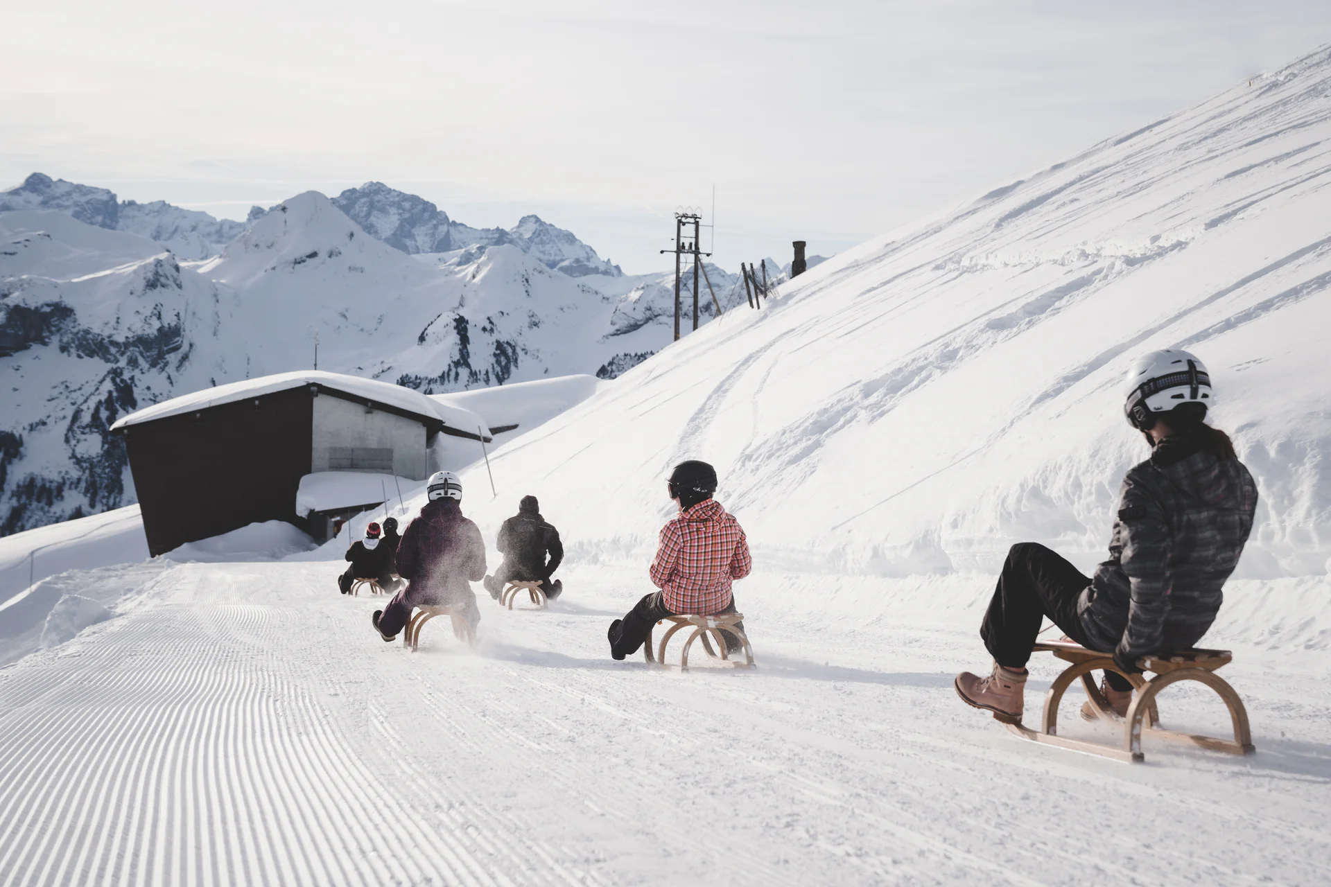 Sledding on Fronalpstock near Stoos in winter