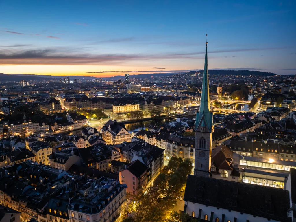 Zurich skyline at night with the Grossmünster towers and city lights