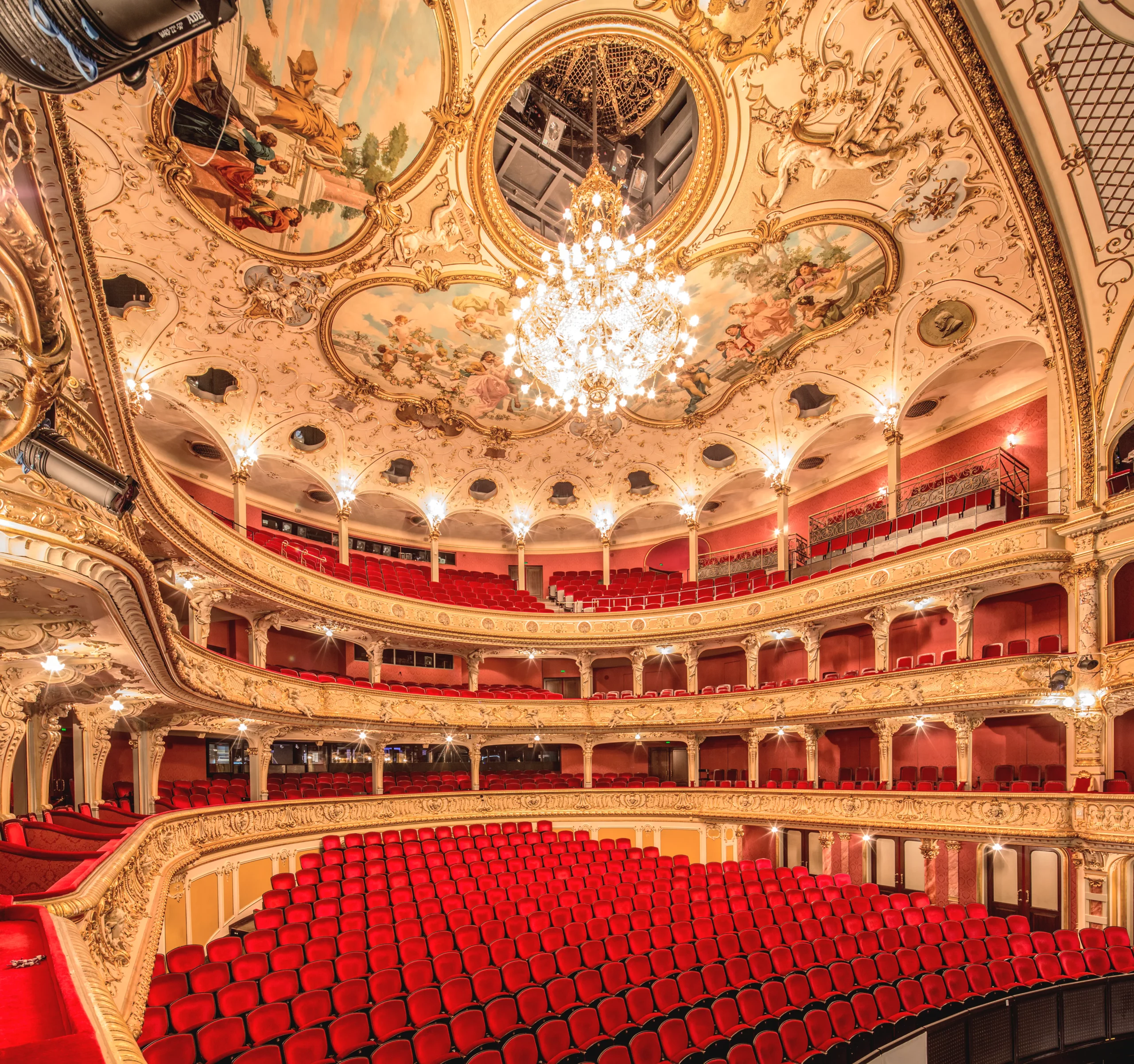 Interior of Zurich Opera House with red seats and ornate ceiling